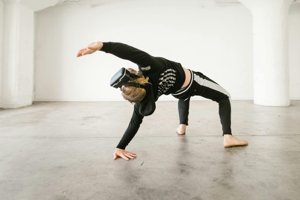 Person wearing VR headset performing a dynamic dance pose in a spacious, minimalist interior.